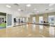 Large common room with hardwood floors, mirrors, and natural light at 5078 Song Sparrow Way, Summerville, SC 29483