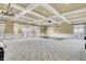 Large community room featuring coffered ceilings, chandeliers, multiple doors/windows, and neutral walls at 5078 Song Sparrow Way, Summerville, SC 29483
