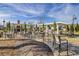 A spacious outdoor community space with dining tables, chairs, barbeque grills, and a fireplace at 5078 Song Sparrow Way, Summerville, SC 29483