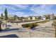 View of a community space with bocce ball court surrounded by beautiful homes under a partially cloudy blue sky at 5078 Song Sparrow Way, Summerville, SC 29483