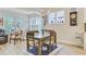 Sunlit dining area with wood table, chandelier, and adjacent windows at 5078 Song Sparrow Way, Summerville, SC 29483