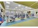 The gym features modern weightlifting equipment, natural light, and a colorful carpet at 5078 Song Sparrow Way, Summerville, SC 29483