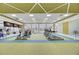 Bright gym featuring modern cardio equipment, large windows, and a high, decorative ceiling at 5078 Song Sparrow Way, Summerville, SC 29483