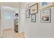 Hallway with view of front door, cabinet and artwork at 5078 Song Sparrow Way, Summerville, SC 29483