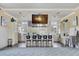 Kitchen with white cabinets, an island with seating, and a large television screen at 5078 Song Sparrow Way, Summerville, SC 29483