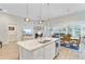 Open-concept kitchen with large island, seamlessly flowing into the living and dining areas at 5078 Song Sparrow Way, Summerville, SC 29483
