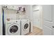 Functional laundry room equipped with a washer, dryer, shelving, and ample storage at 5078 Song Sparrow Way, Summerville, SC 29483