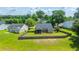 Aerial view of a backyard with house, fenced perimeter, trees, and lush green lawn at 5128 Thornton Dr, Summerville, SC 29485
