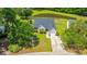 Charming home with well-manicured lawn and a pond view, complete with an attached single-car garage and mature trees at 5128 Thornton Dr, Summerville, SC 29485
