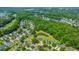 An aerial view of the neighborhood showcases lush landscaping, nearby trees, and the pond at 5128 Thornton Dr, Summerville, SC 29485