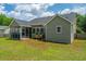 Tan house with a screened-in back patio and flower boxes in a well-kept green yard at 5128 Thornton Dr, Summerville, SC 29485