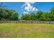 Long backyard view, with fencing, green grass, shade trees and blue sky at 5128 Thornton Dr, Summerville, SC 29485