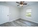 This bedroom offers neutral walls, wood-look flooring, and a ceiling fan at 5128 Thornton Dr, Summerville, SC 29485
