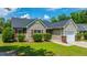 Attractive one story home featuring red shutters, green shrubs, manicured lawn, and an attached single-car garage at 5128 Thornton Dr, Summerville, SC 29485