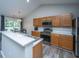 Modern kitchen features wood cabinetry, stainless steel appliances, and an eat-in countertop area at 5128 Thornton Dr, Summerville, SC 29485