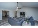 Spacious living room featuring a vaulted ceiling, fan, and seamless transition to the kitchen and dining area at 5128 Thornton Dr, Summerville, SC 29485