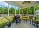 A screened-in patio with gas grill, plants, and a shady outdoor view at 5128 Thornton Dr, Summerville, SC 29485