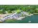 An aerial view showcases the lakeside restaurant, boat docks, parking, and surrounding greenery at 513 Pauline Dr, Bonneau, SC 29431