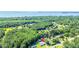Aerial view of a property showcasing the house, outbuildings, and surrounding trees in proximity to the waterway at 513 Pauline Dr, Bonneau, SC 29431