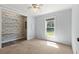 Cozy bedroom with patterned accent wall and a sunlit window overlooking the backyard at 513 Pauline Dr, Bonneau, SC 29431