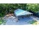 Exterior of a carport with a light blue roof and supports, surrounded by trees at 513 Pauline Dr, Bonneau, SC 29431