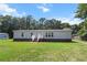 Charming home featuring brick foundation and a cozy front porch with white railing, set on a well-maintained lawn at 513 Pauline Dr, Bonneau, SC 29431