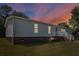 Charming single-Gathering home featuring vinyl siding, brick foundation and a cozy front porch with white railing at 513 Pauline Dr, Bonneau, SC 29431