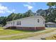 Charming exterior view of home with a well-kept lawn and shed at 513 Pauline Dr, Bonneau, SC 29431