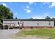 Exterior view of a single-story house with a metal roof and a small porch at 513 Pauline Dr, Bonneau, SC 29431
