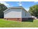 Rear view of home features vinyl siding, brick foundation, and a well-maintained front lawn at 513 Pauline Dr, Bonneau, SC 29431