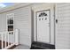 Close up of the front door and porch with sidelight windows and a doorbell at 513 Pauline Dr, Bonneau, SC 29431