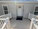 Close up of the front door and porch with sidelight windows at 513 Pauline Dr, Bonneau, SC 29431
