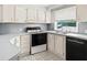 Well-lit kitchen with a window view, black appliances, and light-colored cabinets at 513 Pauline Dr, Bonneau, SC 29431