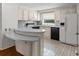 Cozy kitchen featuring white cabinets, appliances, and a breakfast bar for casual dining at 513 Pauline Dr, Bonneau, SC 29431