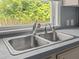 Close-up of kitchen sink that offers backyard scenery from window at 513 Pauline Dr, Bonneau, SC 29431