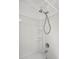 Corner shower and bathtub with a chrome shower head and faucet, with corner shelves at 513 Pauline Dr, Bonneau, SC 29431