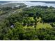 Breathtaking aerial shot of a charming home nestled among lush trees and scenic waterfront views at 6434 Saint Anthony Dr, Meggett, SC 29449