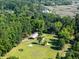 Expansive wooded property with a horse barn, paddock, and fenced training ring near winding creeks at 6434 Saint Anthony Dr, Meggett, SC 29449
