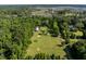 Expansive aerial view showcasing the property's large lot, open fields, and serene wooded surroundings at 6434 Saint Anthony Dr, Meggett, SC 29449