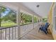 Long back porch with chairs provides a view of the wooded yard at 6434 Saint Anthony Dr, Meggett, SC 29449