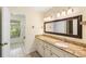 Bathroom with large mirror, granite countertops, and good lighting plus access to enclosed tub at 6434 Saint Anthony Dr, Meggett, SC 29449