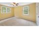 Bedroom with neutral walls, neutral carpet, ceiling fan, and multiple windows at 6434 Saint Anthony Dr, Meggett, SC 29449