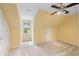 Upstairs bonus room with neutral carpet, neutral walls, attic storage, and a large window at 6434 Saint Anthony Dr, Meggett, SC 29449