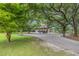 Charming two-story home with a screened porch and driveway, surrounded by mature trees at 6434 Saint Anthony Dr, Meggett, SC 29449