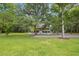 Charming two-story home with a screened porch and lush green lawn, surrounded by mature trees at 6434 Saint Anthony Dr, Meggett, SC 29449
