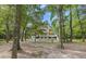 Charming two-story home with a screened porch nestled among mature trees, offering privacy at 6434 Saint Anthony Dr, Meggett, SC 29449