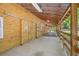 Horse barn exterior featuring stalls with wooden doors, concrete and sand floor, and a well-lit environment at 6434 Saint Anthony Dr, Meggett, SC 29449