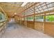 Horse barn interior featuring ample space, stalls with wooden doors, and a well-lit environment at 6434 Saint Anthony Dr, Meggett, SC 29449