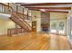 Spacious living room with fireplace, wooden beams, and hardwood floors at 6434 Saint Anthony Dr, Meggett, SC 29449