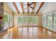 Bright living room featuring a brick fireplace and wooded views from multiple windows at 6434 Saint Anthony Dr, Meggett, SC 29449